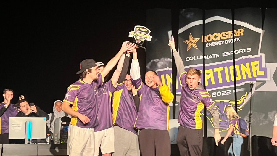 Maverick Esports COD Purple Team cheer on stage and hold up trophy after tournament win