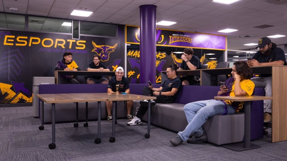 The gaming and esports lounge with couches and tables where many students are sitting and talking